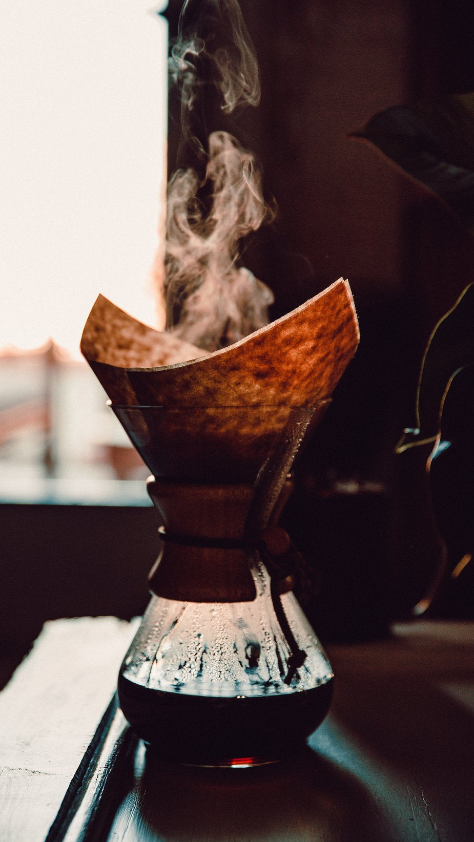 Coffee brewing in a Chemex-style pourover brewer.